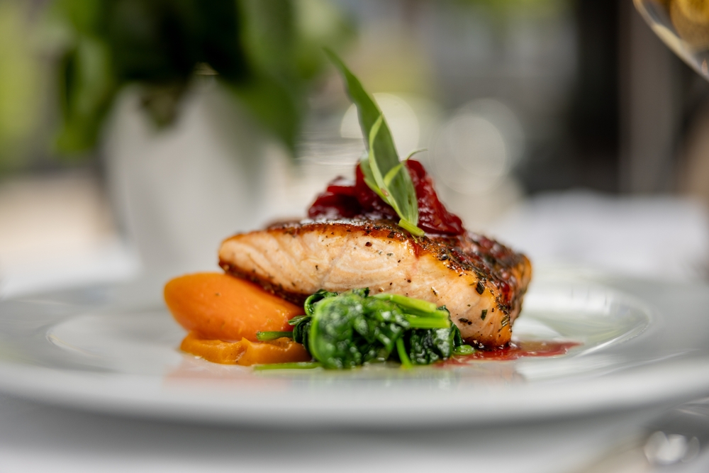 Delicious gourmet salmon seafood meal entree at fancy restaurant